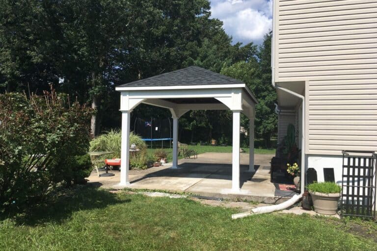 Projects 12 10x14 Shoreline Vinyl pavilion next to home over concrete pavers