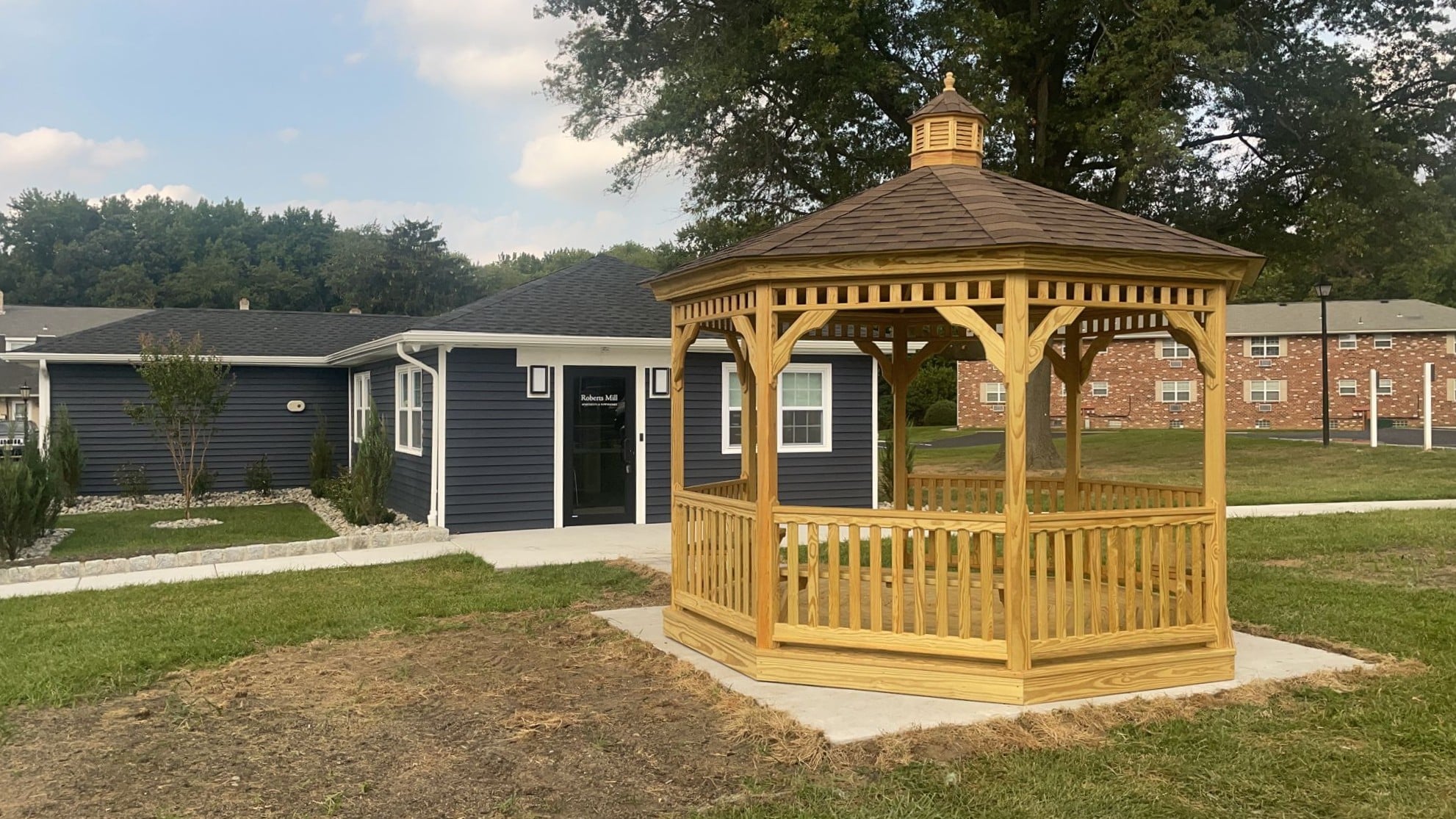 Wood Octagon Gazebo in yard outside home