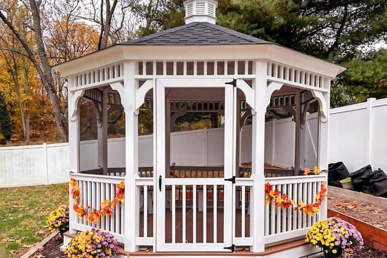 Projects 19 12x12 Vinyl Octagon Gazebo in backyard with autumn decorations and plants
