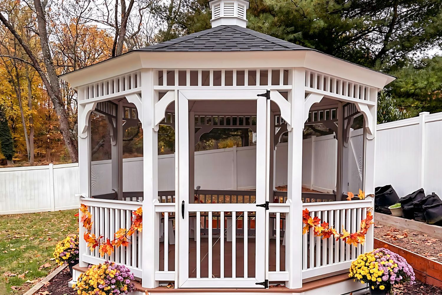 12x12 Vinyl Octagon Gazebo 1 12x12 Vinyl Octagon Gazebo in backyard with autumn decorations and plants