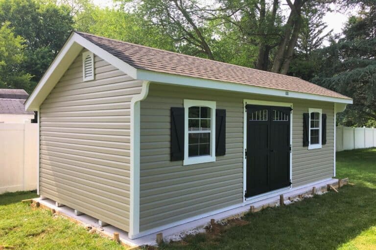 Projects 6 12x14 Vinyl Designer Carriage Shed on a concrete pad in backyard