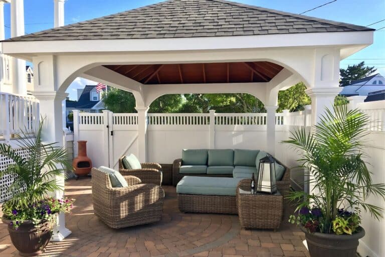 Projects 1 White Vinyl Montford Pavilion over seating area with plants