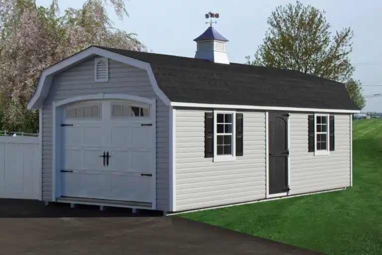 12x26 Vinyl Designer High Barn garage shed in a backyard in front of white fence