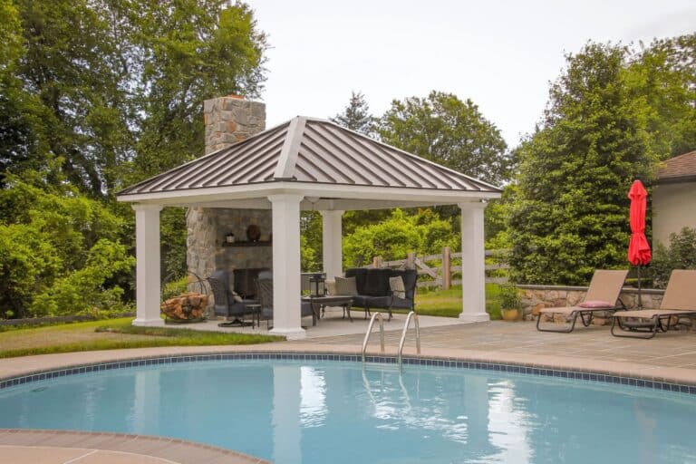 Projects 7 Caribbean Vinyl Pavilion poolside with seating area and fireplace attached