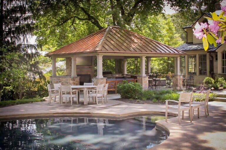Projects 6 Caribbean Vinyl Pavilion with metal roof besides pool with outdoor kitchen and seating underneath