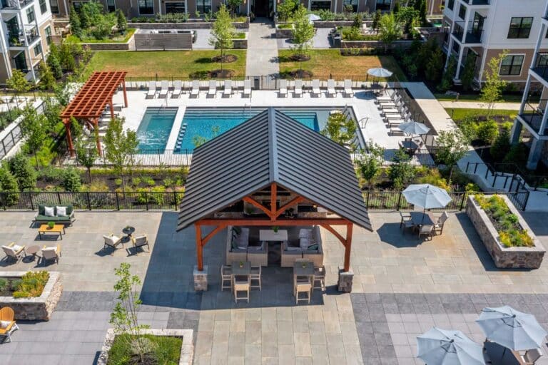 Projects 1 Aerial view of 20x20 Kingston Pavilion and 7x20 Boulder Pergola besides pool outside apartment building in Newton Square PA