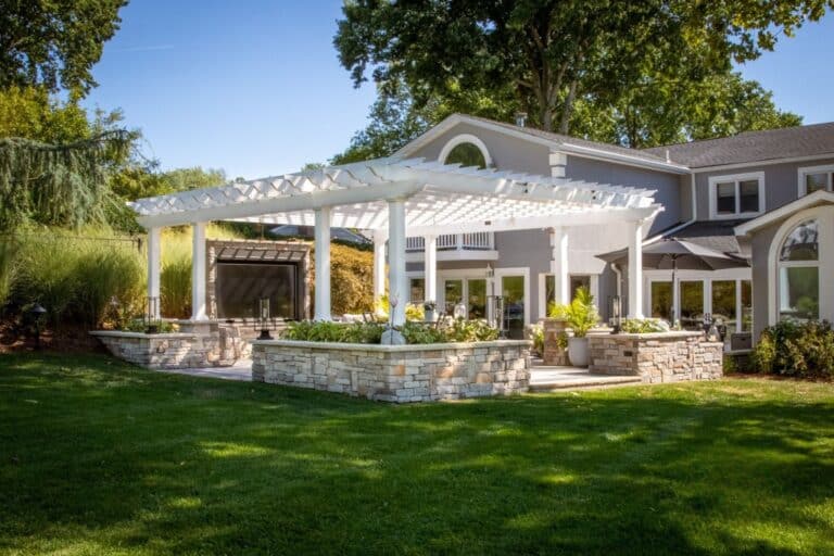 Projects 12 18x22 Carolina Vinyl Pergola at distance, in front of house