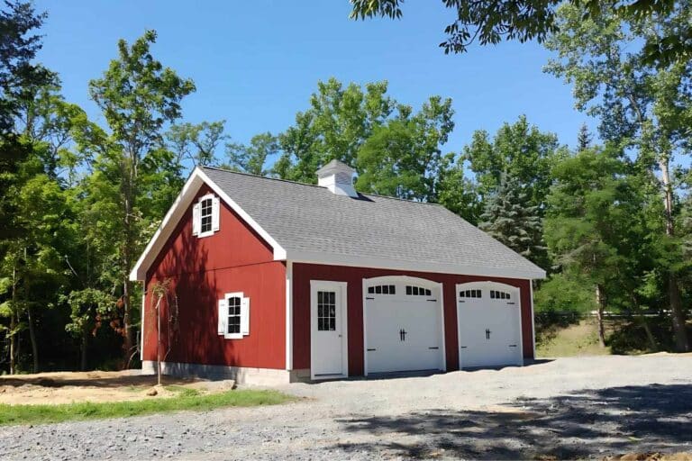 Projects 11 Red A-Frame attic garage at distance with white doors, trim, and cupola