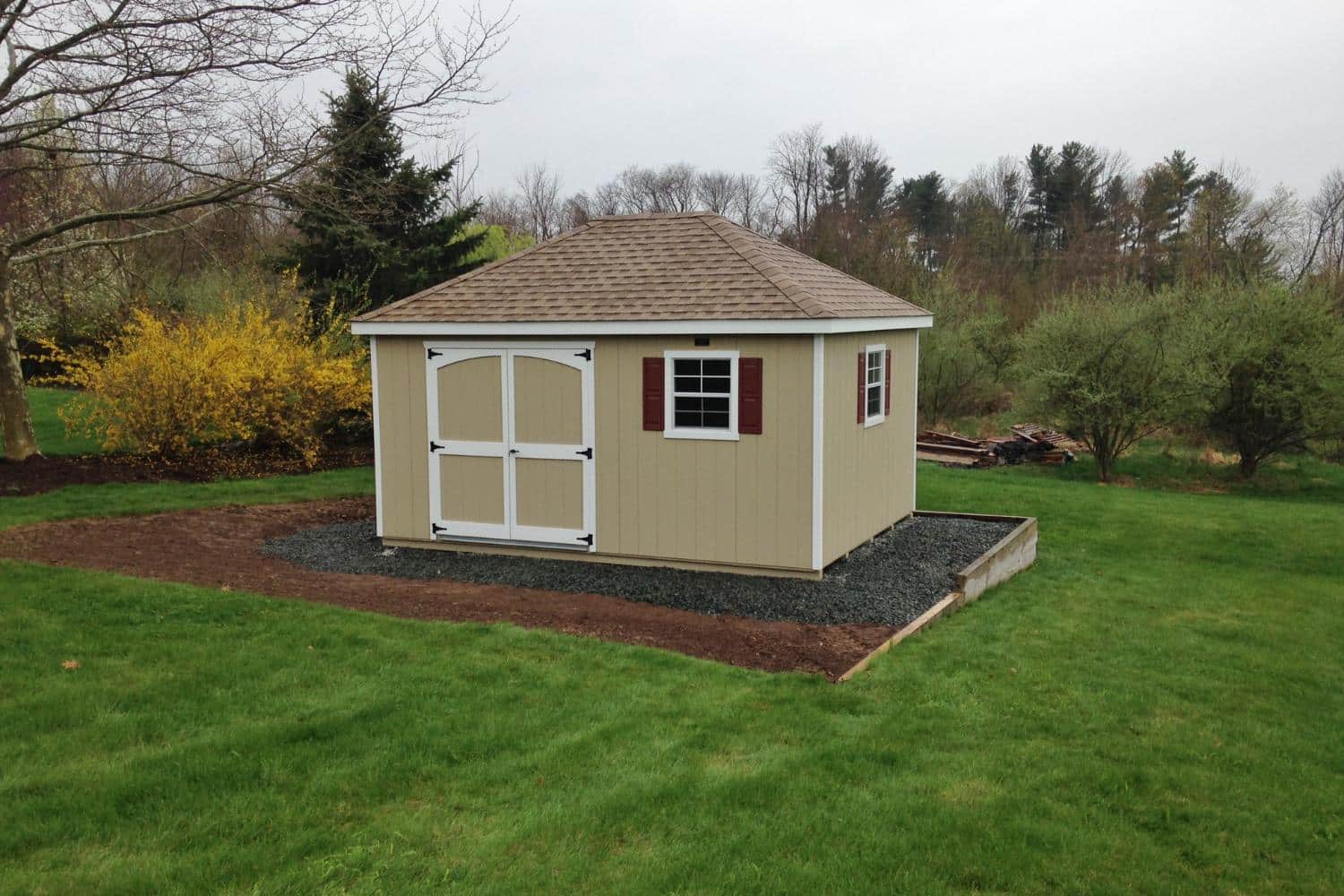 Cabana Shed with wood exterior on gravel pad in backyard