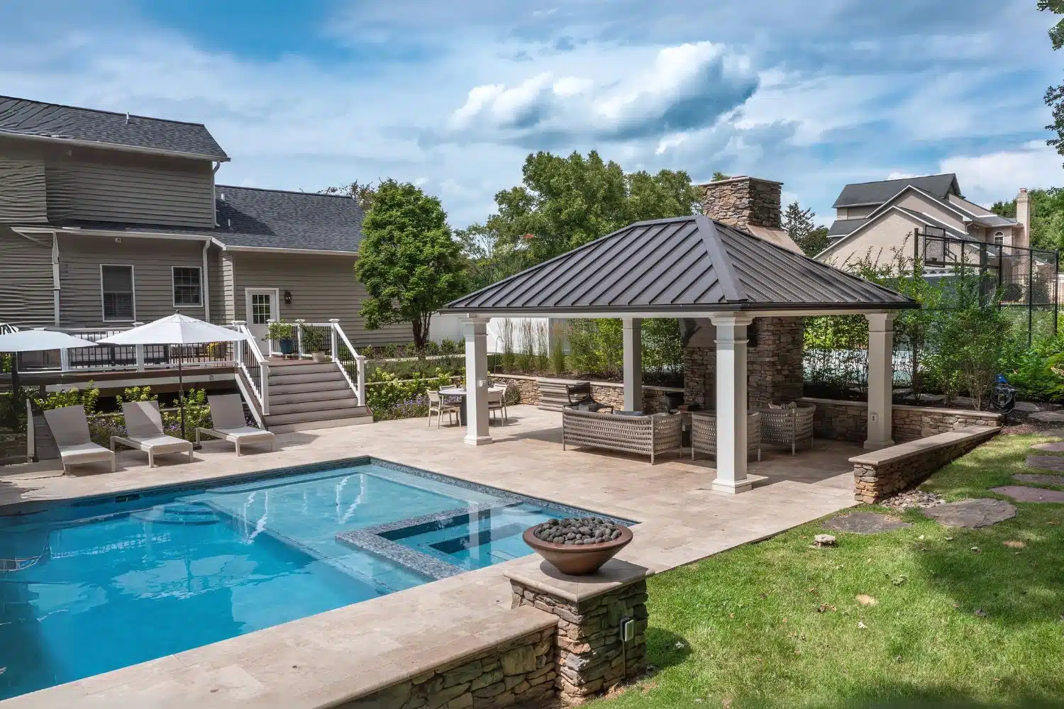 Outdoor Living Caribbean Pavilion besides pool with seating underneath