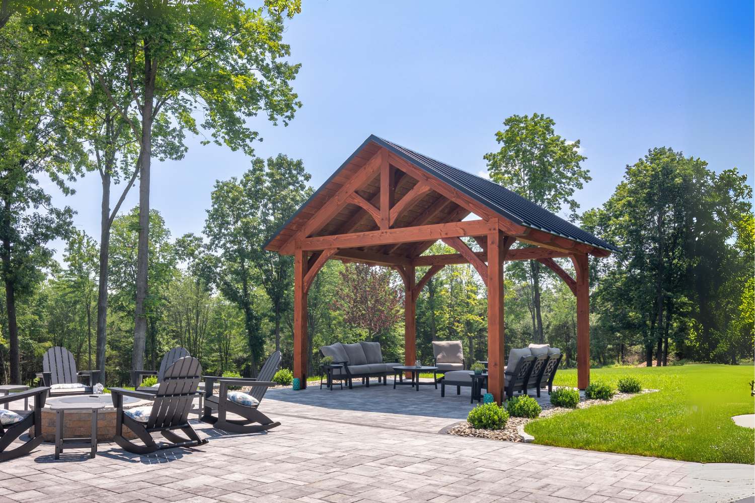 The Kingston Timber Frame Pavilion with patio and seating underneath