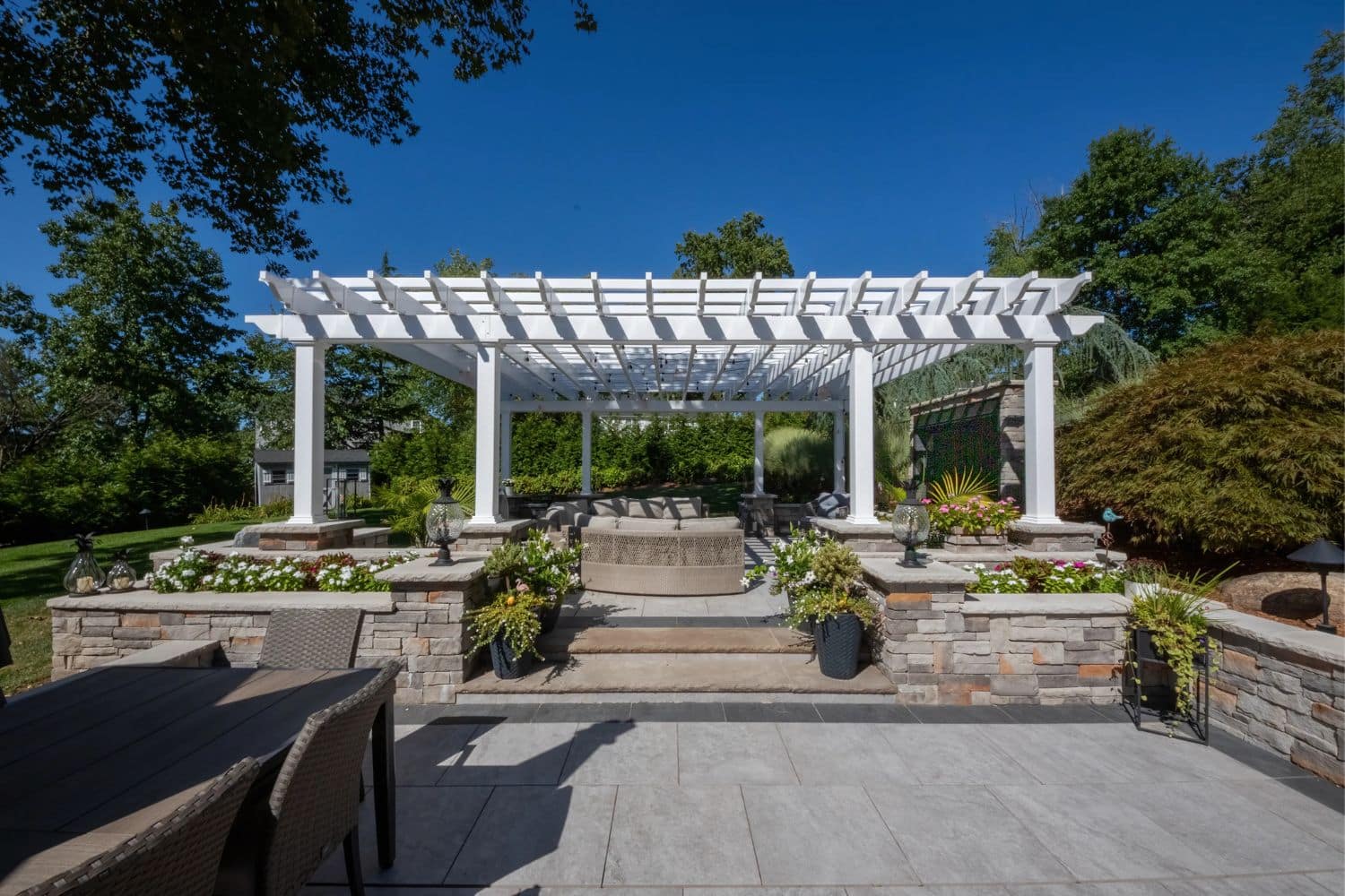 Carolina vinyl pergola over large stone garden and seating area