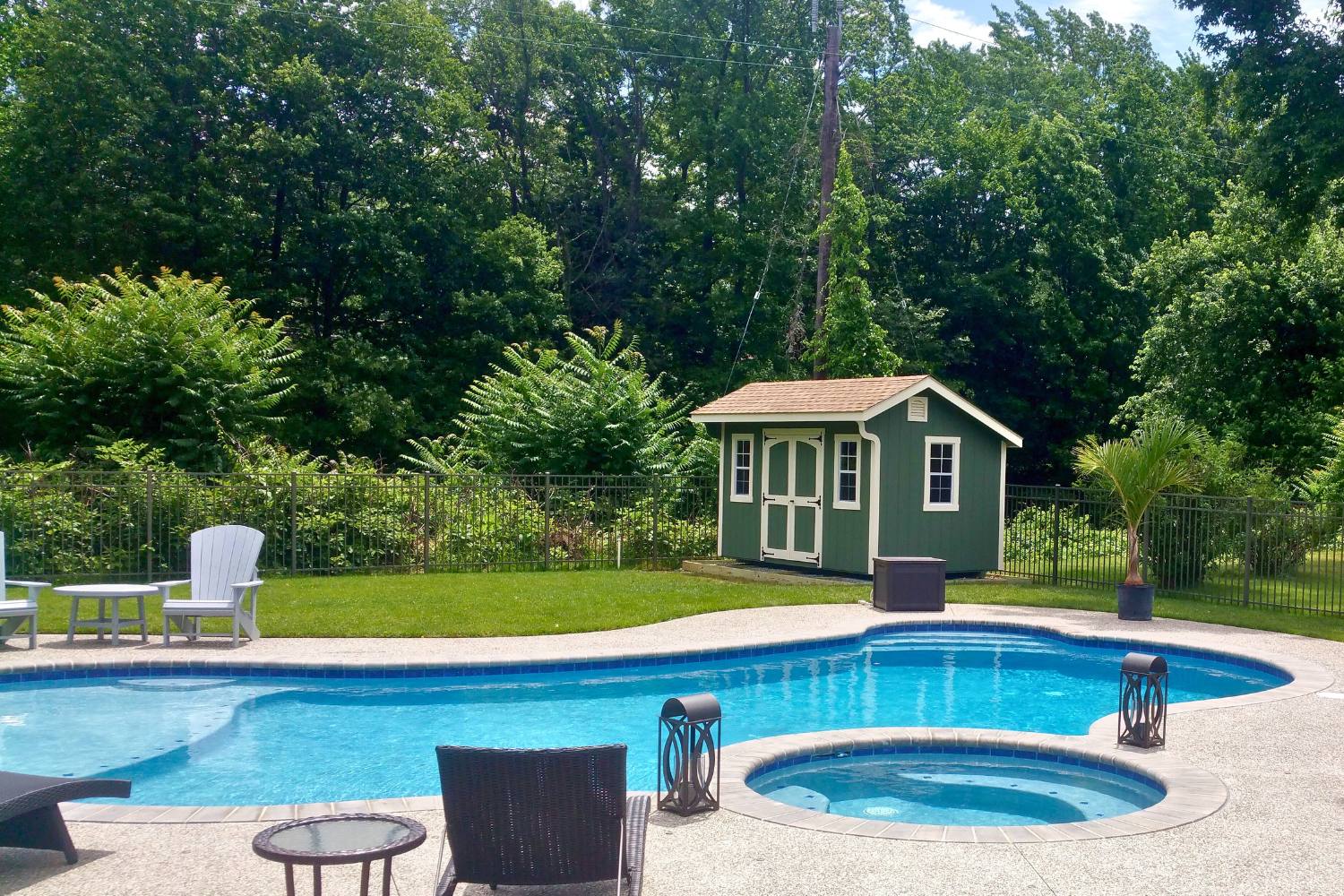 The Designer Carriage Shed 2 Green designer carriage shed across from pool and against tree area