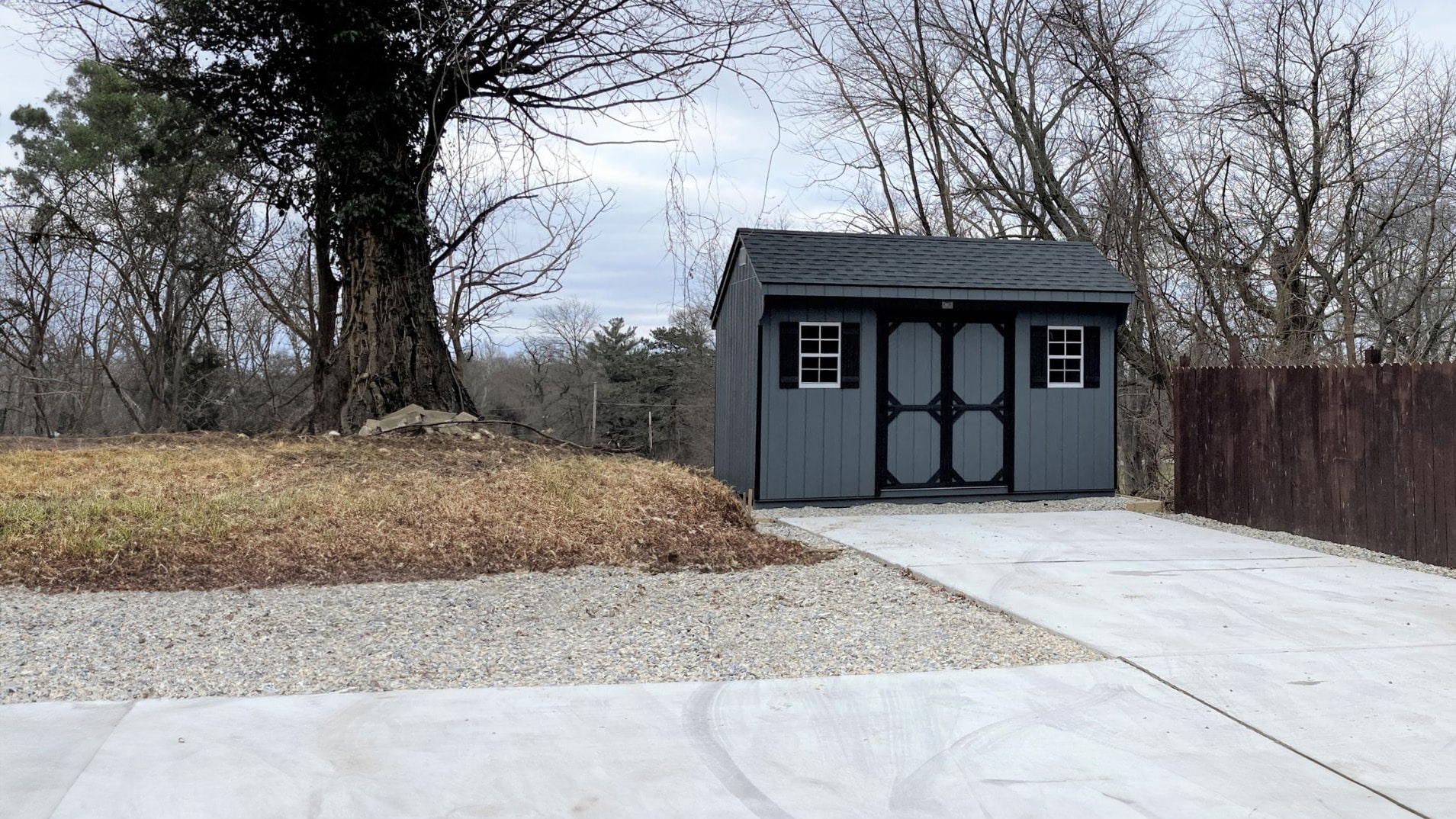 The Standard Carriage Shed 1 Dark gray standard carriage shed on driveway with dark trim