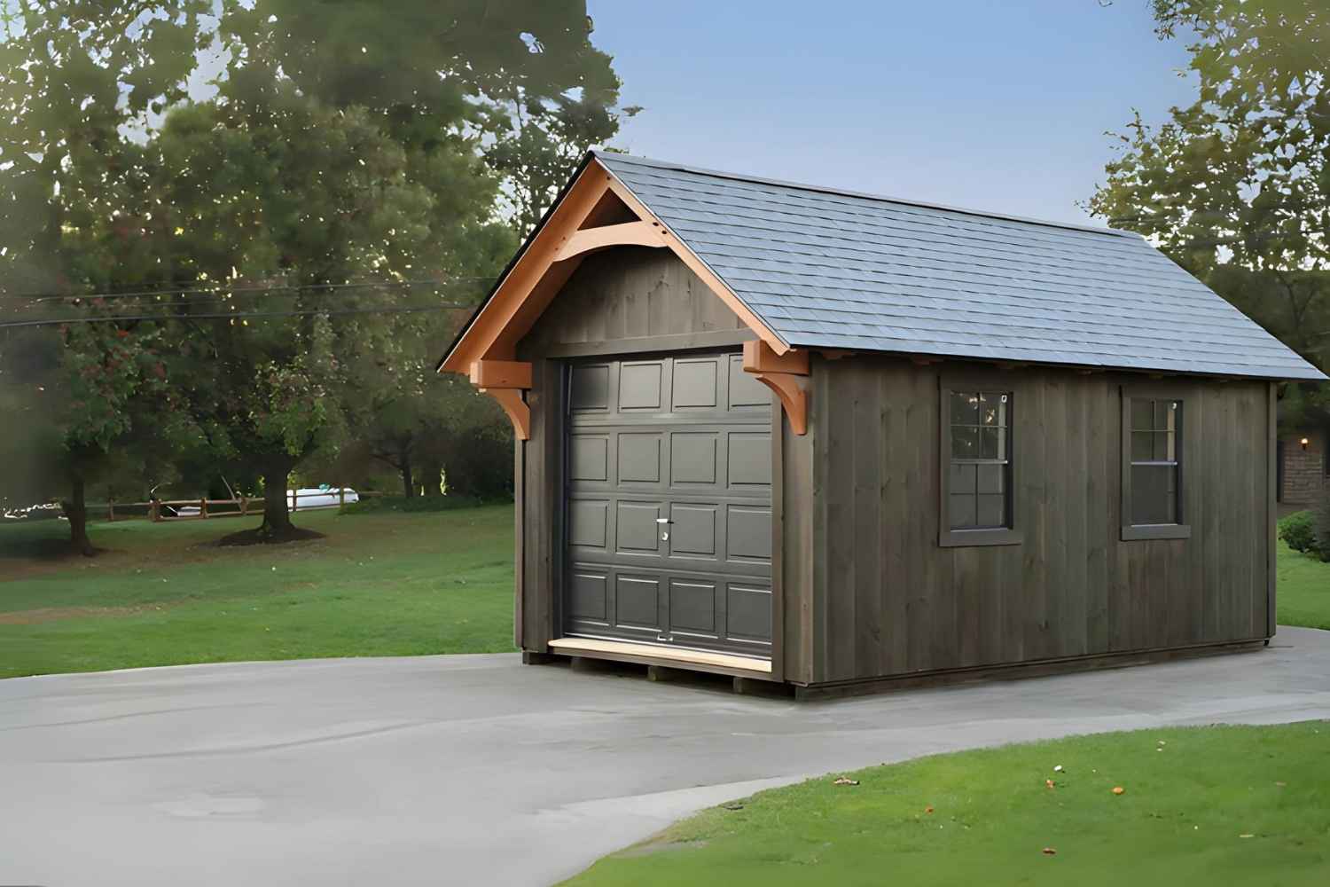 The York Shed on driveway with dark gray siding and black garage door